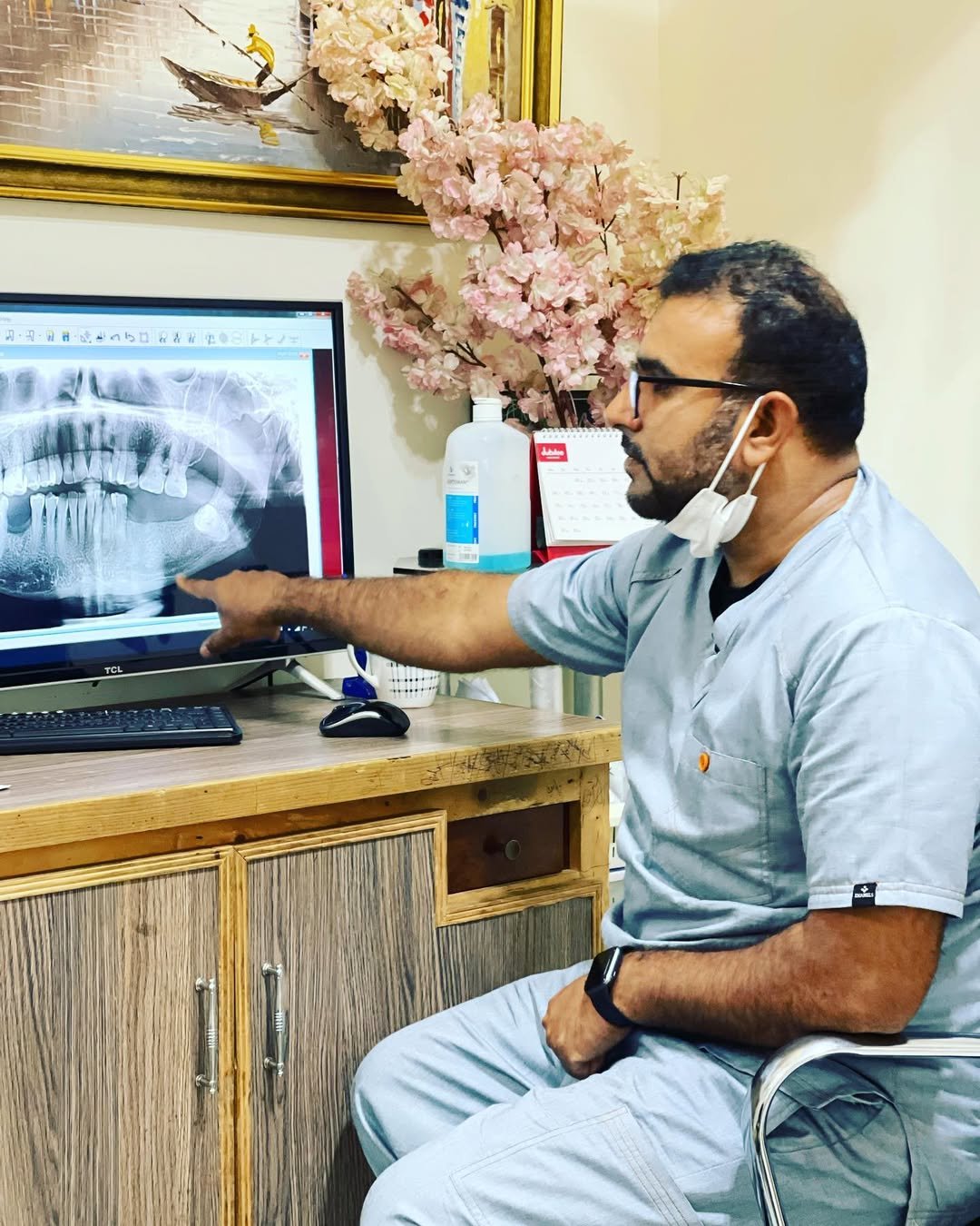 Dr. Sheraz reviewing a digital dental X-ray with a patient